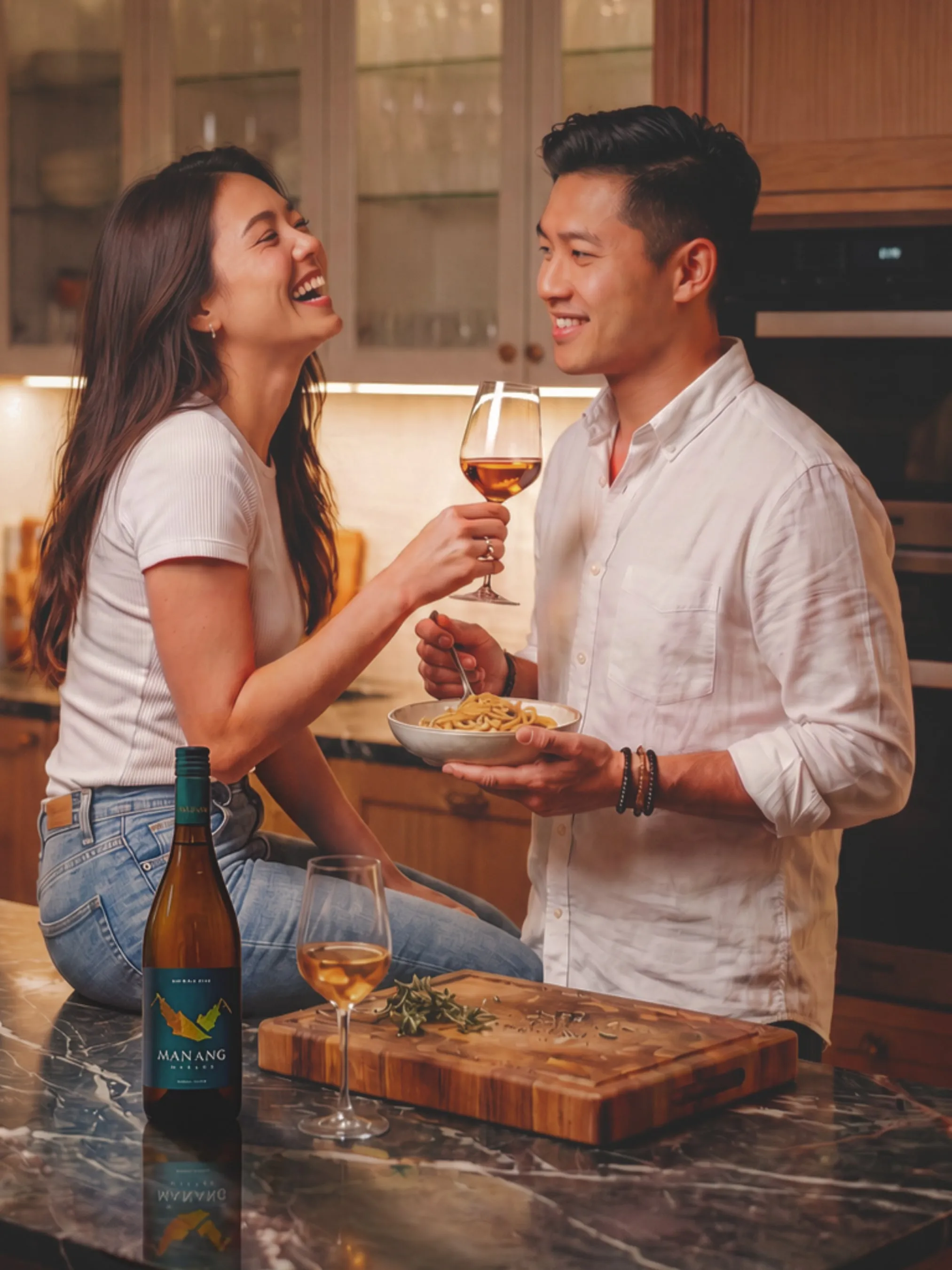 A couple sharing wine and dinner in the kitchen